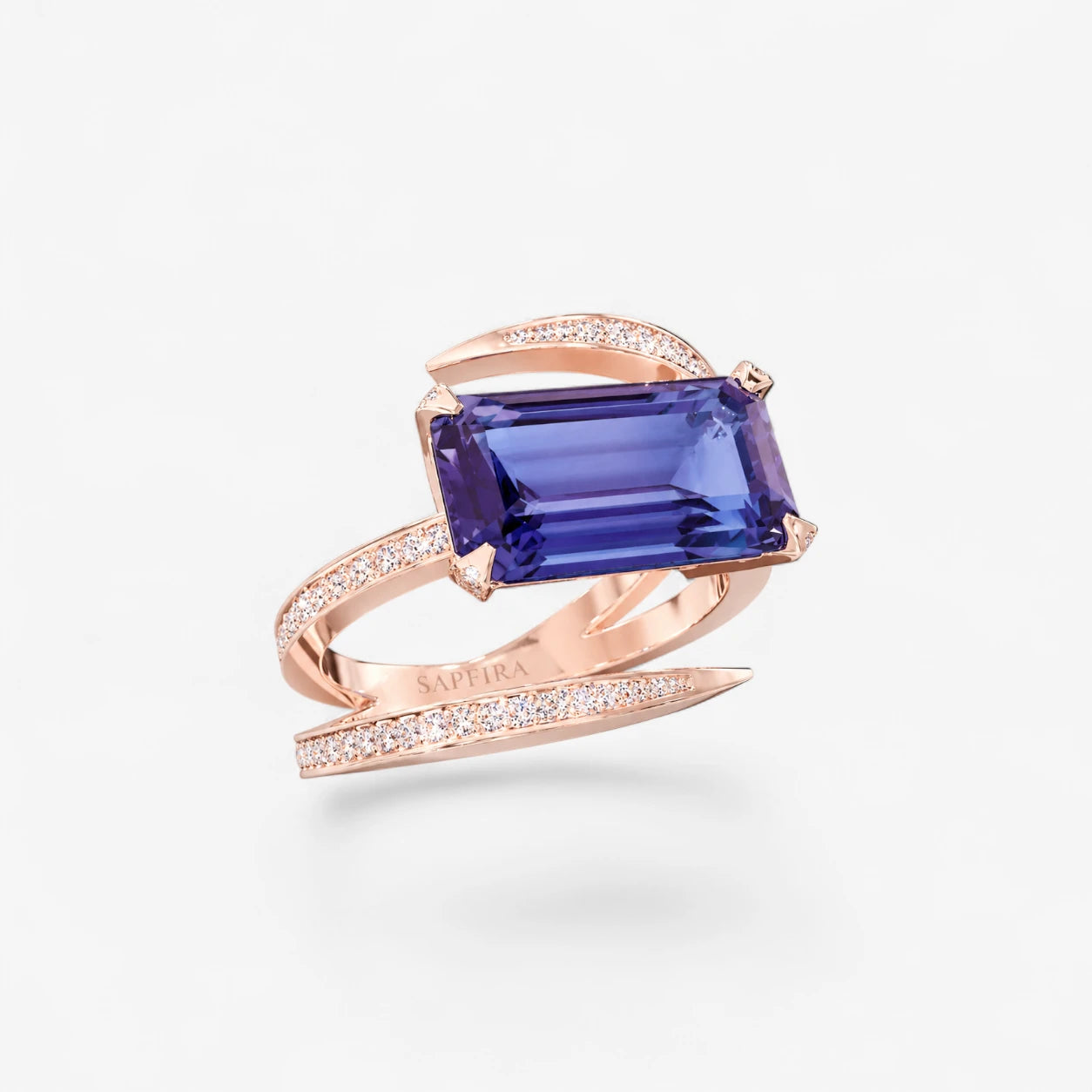 Rose gold ring with tanzanite gemstone on a white background