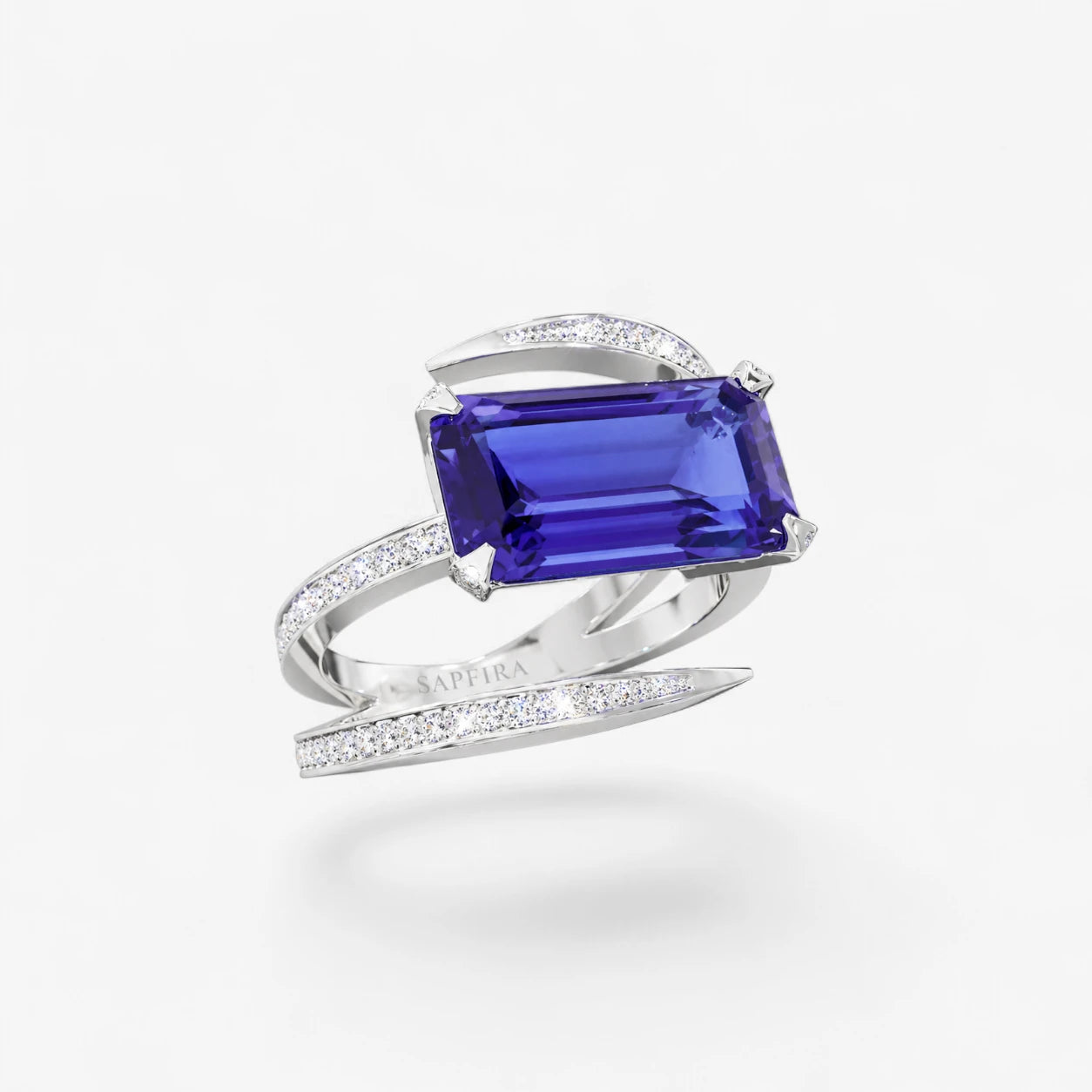 Elegant ring with a blue gemstone and white metal band on a light gray background