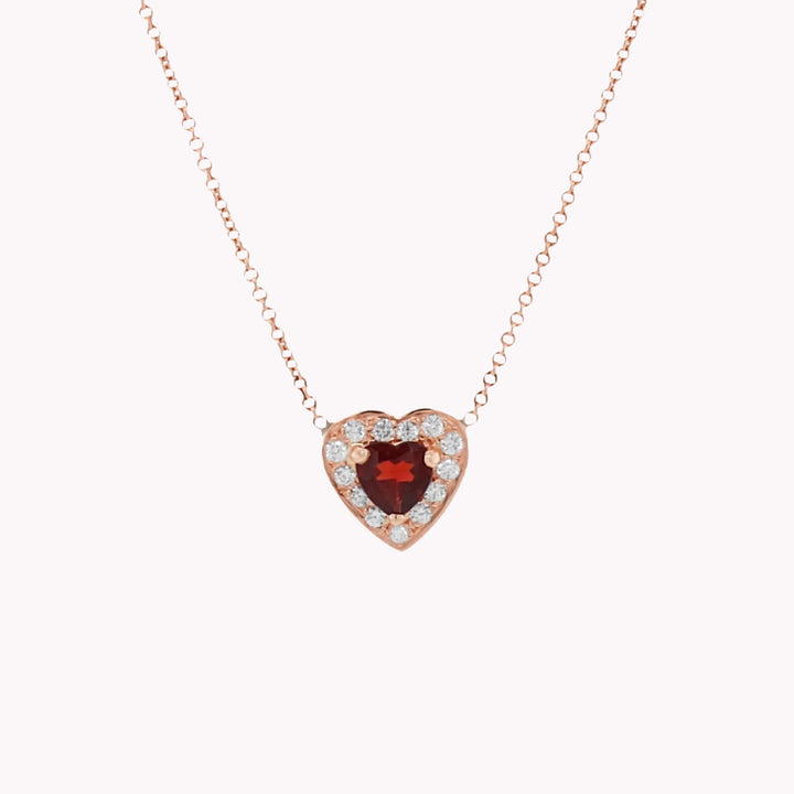 PASSION - SAPFIRA Colliers  This necklace is the representation of passionate and eternal love. Heart-shaped pendant in 18K rose gold with a halo of brilliant diamonds (0.40 cttw). The central stone - Garnet.Chain length: 45 cm